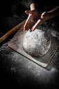 Chef hand clap with splash of white flour and black background with copy space. woman`s hands Making bread Royalty Free Stock Photo