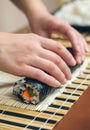 Woman chef hands rolling up japanese sushi Royalty Free Stock Photo