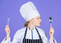 Woman chef hold utensil spoon fork. Appetite and taste. Traditional culinary meal. Professional cook and cooking at home Royalty Free Stock Photo