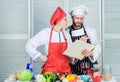 Woman chef and man cooking food together. Culinary family concept. Couple in love cooking healthy recipe. Amateur cook Royalty Free Stock Photo