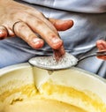 Woman chef mixes ingredients for baking closeup.