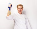 Woman in chef outfit and first prize medal smiling.