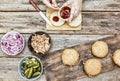 The woman-chef prepares burgers. Burger burgers and burger ingredients on a wooden kitchen table Royalty Free Stock Photo