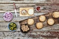 The woman-chef prepares burgers. Burger burgers and burger ingredients on a wooden kitchen table Royalty Free Stock Photo