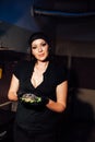 Beautiful woman chef prepares a hamburger in the kitchen of the restaurant Royalty Free Stock Photo