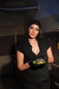 Beautiful woman chef prepares a hamburger in the kitchen of the restaurant Royalty Free Stock Photo