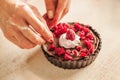 Woman chef preparing chocolate cake with whipped cream and raspberry Royalty Free Stock Photo