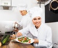 Woman chef serving fresh salad Royalty Free Stock Photo