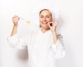 Woman chef showing a sign perfect, with pasta noodle on fork. Royalty Free Stock Photo