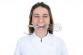 Woman chef showing whisk pastry whip in the mouth between female teeth on white background