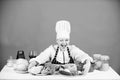 Woman chef wear hat apron near table ingredients. Girl adorable chef teach culinary. Best culinary recipes to try at Royalty Free Stock Photo