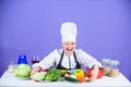 Woman chef wear hat apron near table ingredients. Girl adorable chef teach culinary. Best culinary recipes to try at Royalty Free Stock Photo