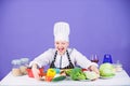 Woman chef wear hat apron near table ingredients. Girl adorable chef teach culinary. Best culinary recipes to try at Royalty Free Stock Photo