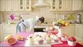 Woman cheking whether cakes are ready in the oven