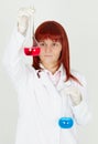 Woman chemist with colored flasks