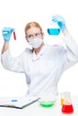 Woman chemist lab assistant with test tubes doing substance