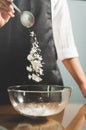 Woman chief sprinkling flour Royalty Free Stock Photo