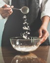 Woman chief sprinkling flour Royalty Free Stock Photo