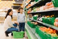 Woman and child boy during family shopping with trolley at supermarket Royalty Free Stock Photo