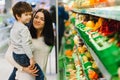 Woman and child boy during family shopping with trolley at supermarket Royalty Free Stock Photo