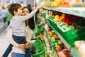 Woman and child boy during family shopping with trolley at supermarket Royalty Free Stock Photo