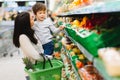 Woman and child boy during family shopping with trolley at supermarket Royalty Free Stock Photo