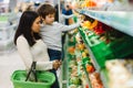 Woman and child boy during family shopping with trolley at supermarket Royalty Free Stock Photo