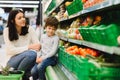 Woman and child boy during family shopping with trolley at supermarket Royalty Free Stock Photo