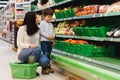 Woman and child boy during family shopping with trolley at supermarket Royalty Free Stock Photo