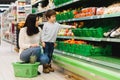 Woman and child boy during family shopping with trolley at supermarket Royalty Free Stock Photo