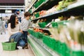 Woman and child boy during family shopping with trolley at supermarket Royalty Free Stock Photo