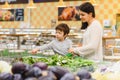 Woman and child boy during family shopping with trolley at supermarket Royalty Free Stock Photo