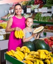 woman with child buying fruits Royalty Free Stock Photo