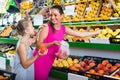 woman with child buying fruits Royalty Free Stock Photo