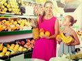 Woman with child buying fruits Royalty Free Stock Photo