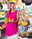 woman with child buying fruits Royalty Free Stock Photo