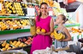 woman with child buying fruits Royalty Free Stock Photo