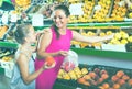 Woman with child buying fruits Royalty Free Stock Photo