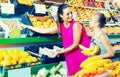 Woman with child buying fruits Royalty Free Stock Photo