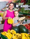 Woman with child buying fruits Royalty Free Stock Photo