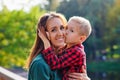 A woman and a child embrace on the bridge, the son kisses his mother on the cheek. Summer family vacation and the concept of love Royalty Free Stock Photo