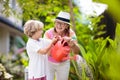 Woman and child gardening. Grandmother and kid