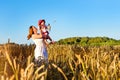 Woman and child in golden ears grain crops field Royalty Free Stock Photo