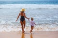 A woman with child by the hand goes along the sea shore Royalty Free Stock Photo