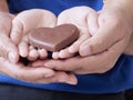 Woman and child holding chocolate heart Royalty Free Stock Photo