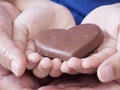 Woman and child holding chocolate heart Royalty Free Stock Photo