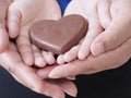 Woman and child holding chocolate heart Royalty Free Stock Photo