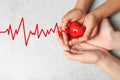 Woman and child holding heart on grey stone background, top view Royalty Free Stock Photo