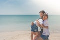 Woman and child hugging and feeling happiness on sand beach with seascape view in the background. Royalty Free Stock Photo