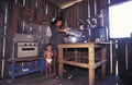 Woman with child Inside a wooden house in Amazonia